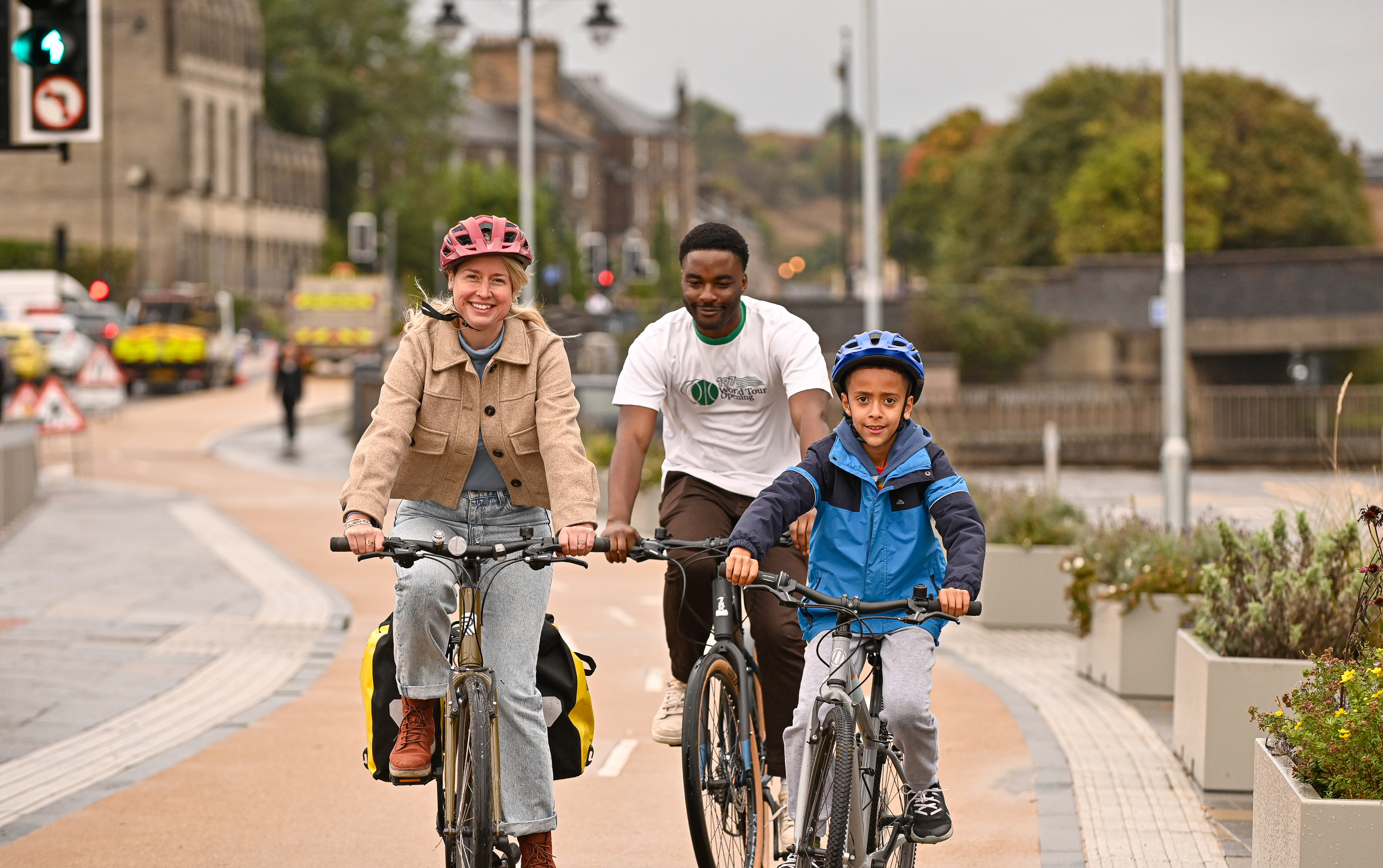 People cycling on a new protected cycle lane in Stirling