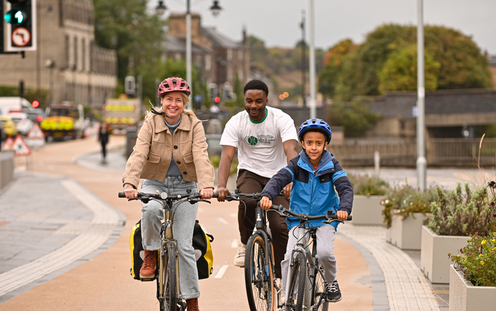People cycling on a new protected cycle lane in Stirling