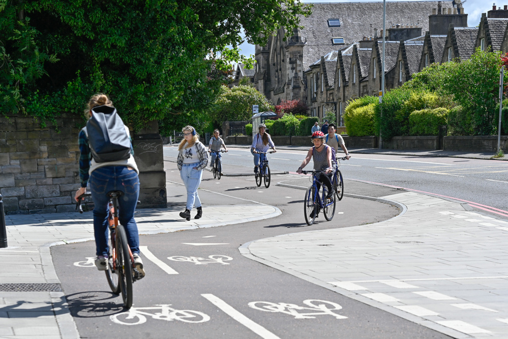 People cycling along the City Centre West to East Link route, at the junction of Wester Coates Terrace in Edinburgh.