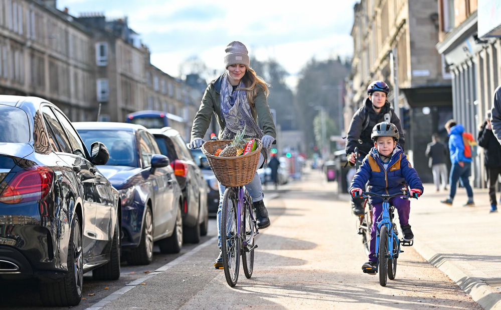 Adults and a child using the South City Way cycle path in Glasgow