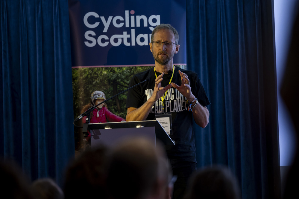 Glenn Lyons, Mott MacDonald Professor of Future Mobility at the University of West of England, addresses the 2025 Cycling Scotland Conference in Dundee
